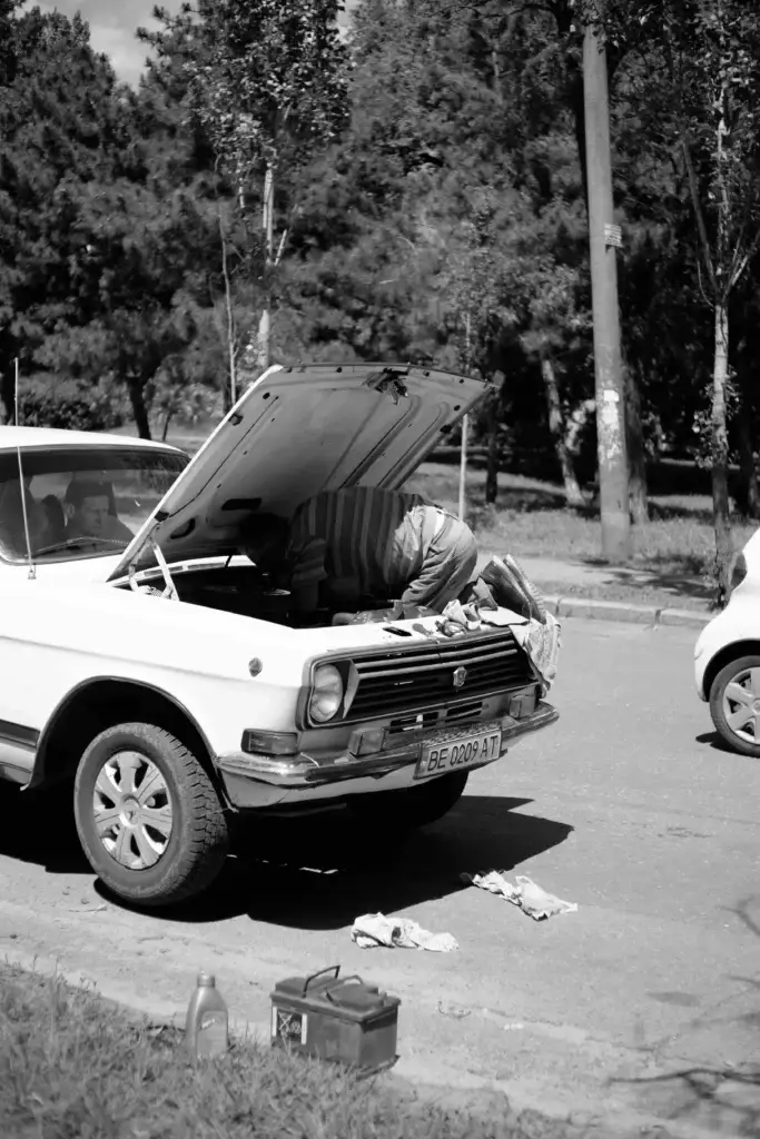 man fixing a car