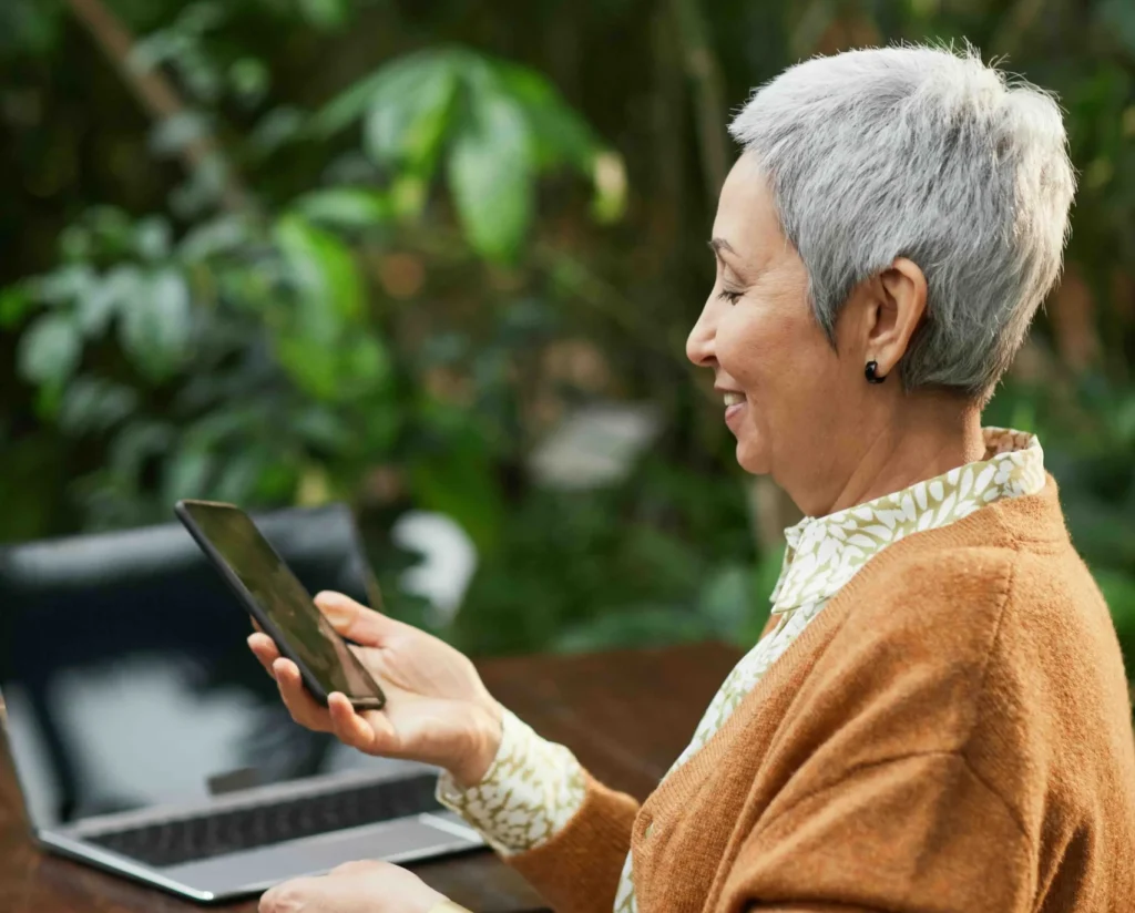 elderly woman using her phone