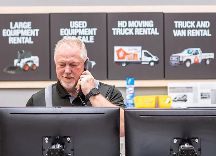 Man having a phone call in the equipment rental store