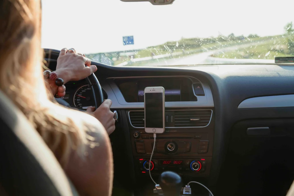 A woman driving with car phone holder