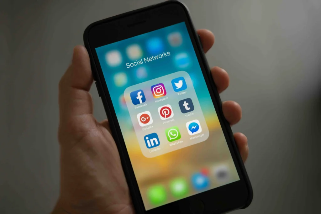 Person holding a phone showing its apps