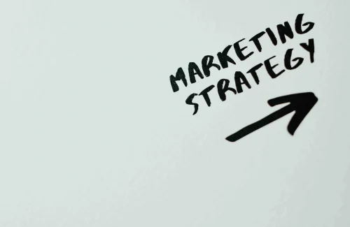 words ''marketing strategy'' with an arrow pointing in the right direction